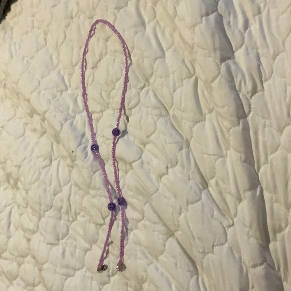 i am selling a purple smiley necklace.